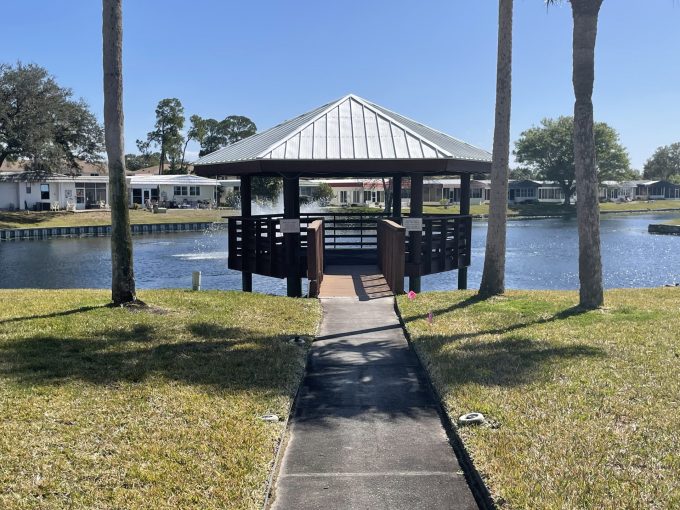 View of a covered dock on a pond in Ranchero Village