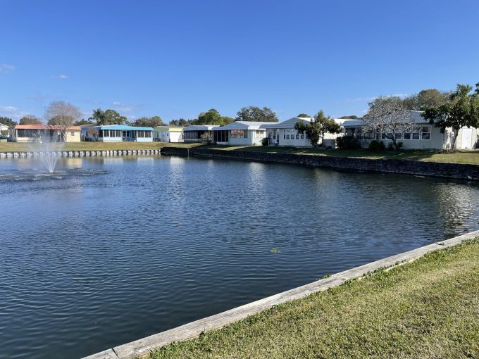 View of homes and a pond with fountain in Ranchero Village